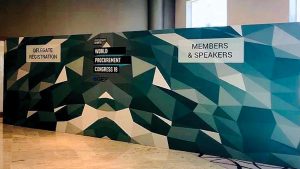 Geometric printed fabric wall with registration and members signs at a congress