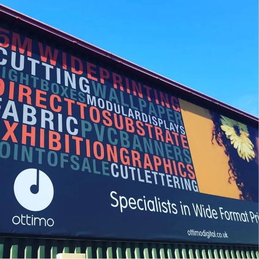 Large Ottimo banner on a building listing wide-format print services