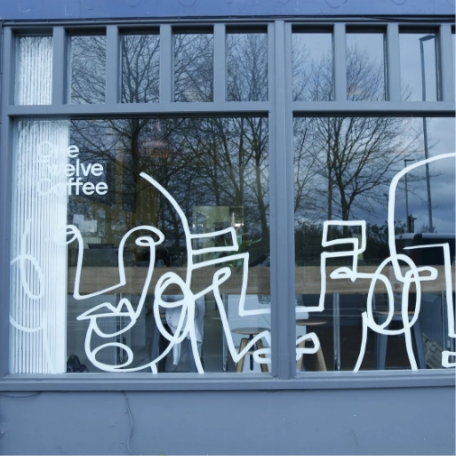 White line-art window graphics on a café shopfront