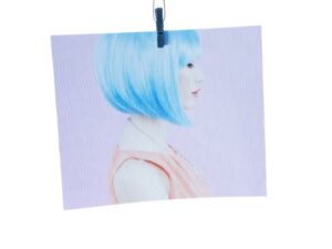 Canvas print of a woman with blue hair, hung from a peg