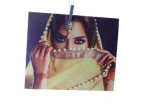 UltraTac print of a woman in a gold veil, hung from a peg
